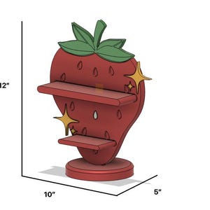 May include: A red strawberry-shaped shelf with two shelves and a green leafy top. The shelf is 12 inches tall, 10 inches wide, and 5 inches deep. Gold star accents are on the side.