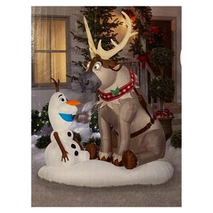 May include: An inflatable outdoor holiday decoration featuring a white snowman with a carrot nose and a brown reindeer with large antlers. The reindeer wears a decorative collar with red, white, and blue patterns and a small green holly accent.