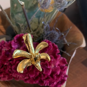 Gold colored orchid pin and charm
