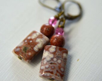 May include: A pair of dangle earrings with pink and brown beads and a brown and white agate stone.