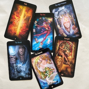 May include: A collection of tarot cards featuring various illustrations and titles. The cards include "Faith," "The Fool," "The High Priestess," "Strength," "The Hermit," and "The Empress." Each card has unique artwork with vibrant colors and detailed imagery, set against a black background.