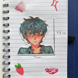 May include: A sticker of an anime-style character with teal hair and green eyes, measuring 7.2 cm tall and 7 cm wide, is placed on a lined notebook page. The character is wearing a gray shirt. Additional red and pink drawings are also on the page.