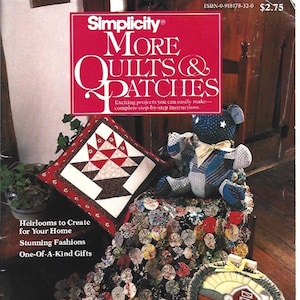 May include: The cover of a Simplicity pattern book titled "More Quilts & Patches" features a red and white design. The image showcases a variety of handmade quilts, including a basket design, a teddy bear, and a barn scene. The book promises exciting projects with step-by-step instructions.