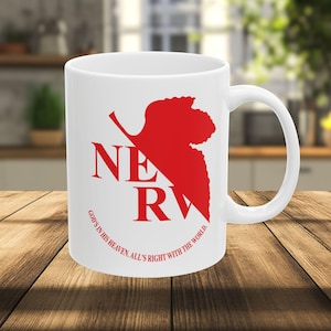 May include: White ceramic mug featuring the red text "NERV" with a stylized red leaf design. The phrase "GOD'S IN HIS HEAVEN, ALL'S RIGHT WITH THE WORLD" is printed in red around the bottom of the mug. The mug has a curved handle.