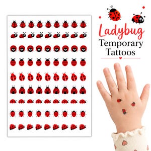 May include: A sheet of temporary tattoos featuring rows of small red and black ladybugs in various orientations. The text Ladybug Temporary Tattoos is printed in red and black. Three ladybug tattoos are applied to the back of a hand.