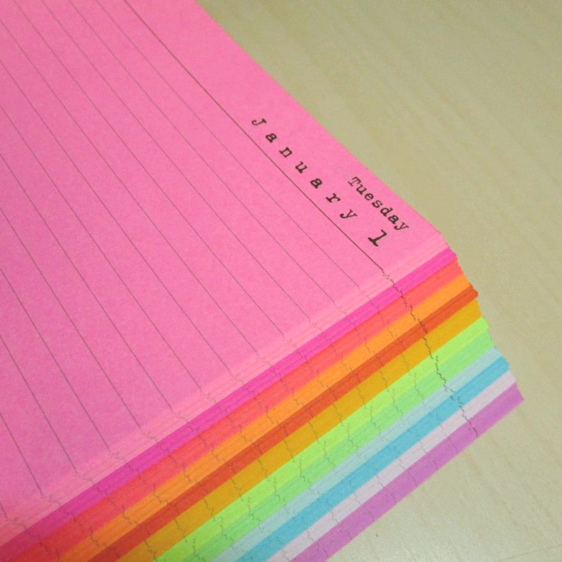 May include: A stack of rainbow lined day per page planner paper