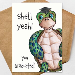 May include: A graduation greeting card featuring a cartoon turtle wearing a graduation cap. The card has the words "shell yeah!" and "You Graduated!" written on it. The turtle is green, blue, and tan, and the card is inside a brown envelope.