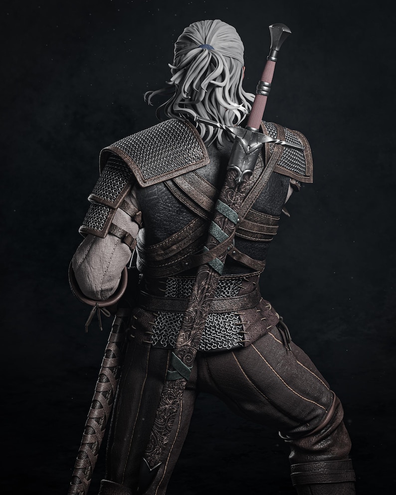 May include: A detailed figurine of a warrior with long white hair tied back, wearing dark brown leather armor with chainmail accents. A long sword in an ornate, dark brown scabbard is strapped to the back, extending above the shoulder.
