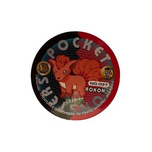May include: A round, red, black, and white Pokemon trading card featuring a cartoon fox-like creature named Vulpix. The card has the text "POCKET" and "NO.037 ROKON" printed on it. The card also has the text "Nintendo CREATURES GAMEFREAK TV TOKYO SHO-PRO-JR KIKAKU".