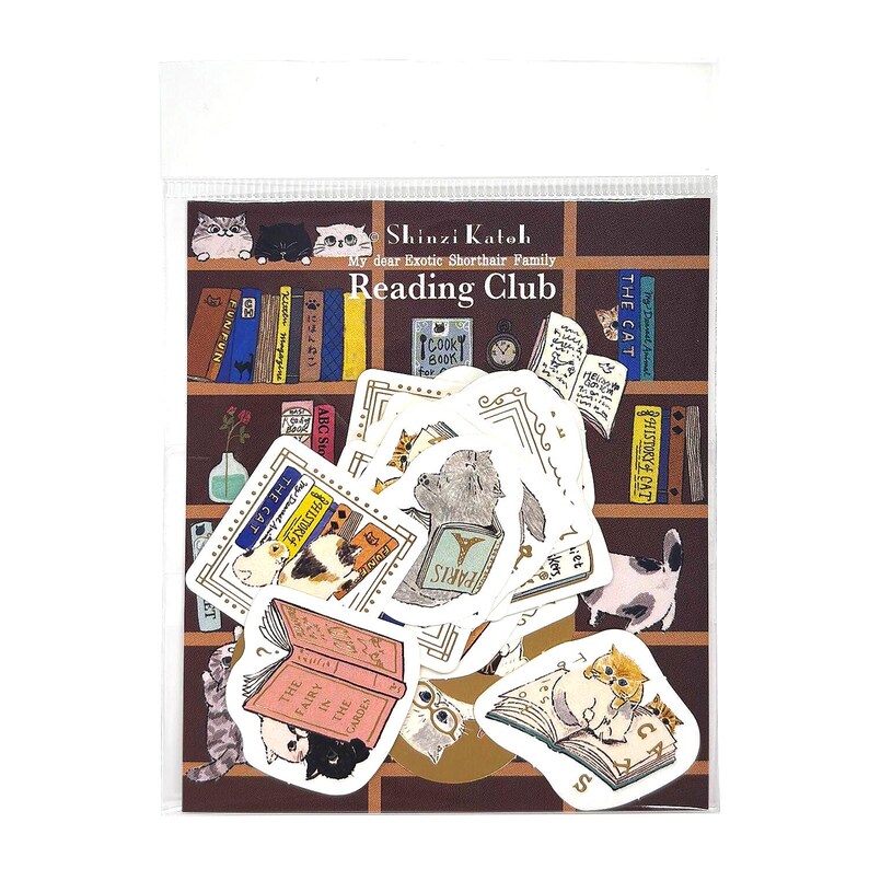May include: A clear plastic package containing a collection of die-cut stickers featuring illustrations of cats reading books. The backing card displays a brown bookshelf background with the text Shinzi Katoh My dear Exotic Shorthair Family Reading Club.