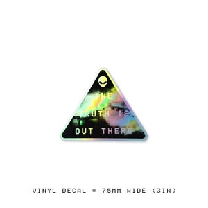May include: A holographic vinyl decal in the shape of a triangle with a black background and a white alien head at the top. The text "THE TRUTH IS OUT THERE" is written in white letters with a glitchy effect.