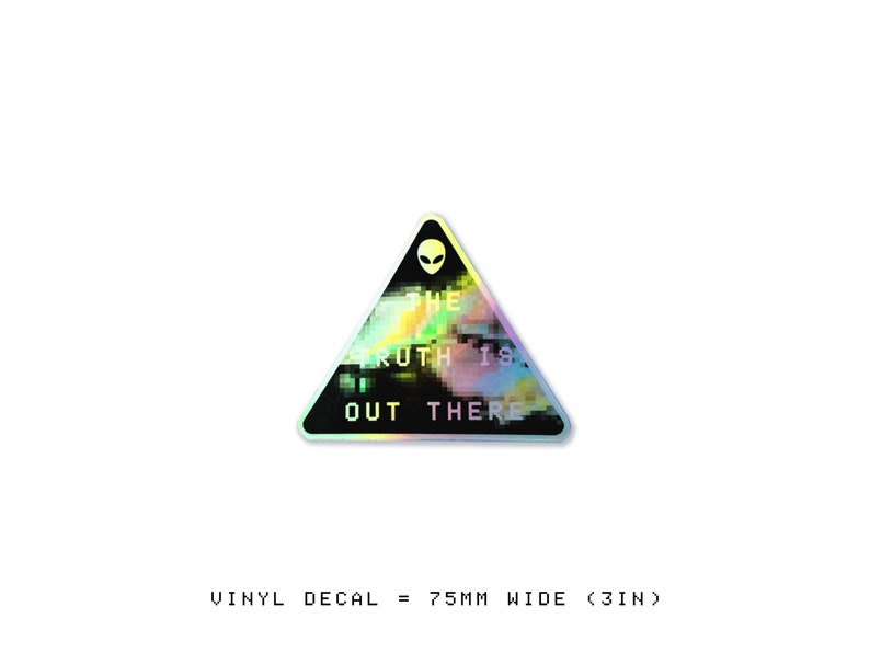 May include: A holographic vinyl decal in the shape of a triangle with a black background and a white alien head at the top. The text "THE TRUTH IS OUT THERE" is written in white letters with a glitchy effect.