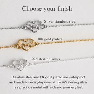 Puede incluir: Tres pulseras de cadena delicadas con un dije de coraz&oacute;n infinito. El texto dice: Choose your finish, Silver stainless steel, 18k gold plated, 925 sterling silver. El acero inoxidable y el chapado en oro de 18k son resistentes al agua, la plata 925 es un metal precioso.