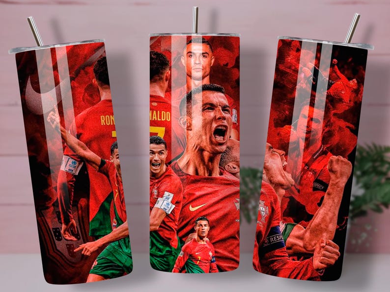 May include: A red and green stainless steel tumbler featuring images of soccer players in action. The design includes a portrait of a soccer player with the name "RONALDO" on the back of the jersey. The tumbler has a silver straw and lid.