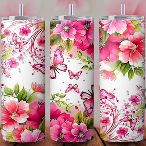 May include: Three stainless steel tumblers with floral and butterfly designs. The tumblers feature a white background with pink flowers and butterflies. The design wraps around the entire tumbler, creating a cohesive and decorative look.