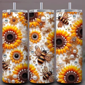 May include: Three white tumblers with a sunflower and bee design. The tumblers feature yellow sunflowers, pearls, and rhinestone accents. The bees have black and yellow stripes. The tumblers have a silver straw.