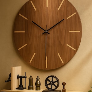 May include: A large, round wooden wall clock with a natural wood grain finish. The clock features black hands and minimalist hour markers. Decorative items, including a small wheel and a wooden block, are displayed below the clock.