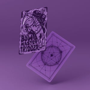 May include: Two purple playing cards with a fantasy illustration. One card features the text "BOW MASTER TRIGGER" and a graphic of an archer. The other card has a geometric design.