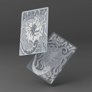 May include: Two rectangular game cards featuring monochromatic gray and white illustrations of tentacled creatures. The top card reads Eldrazi Scion 1/1, and the bottom card reads Eldrazi Spawn 0/1. Both cards include the text SAC and ADD.