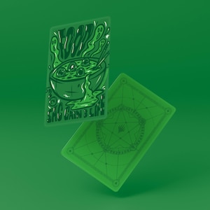 May include: Two green playing cards with a green background. One card features a bowl of food with the word "FOOD" above it and the text "SHC GAIN 3 LIFE" below. The other card has a geometric design.