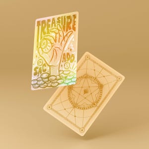 May include: Two rectangular cards with a gold and rainbow design. One card features a hand holding a coin with the words "TREASURE", "SAC", and "ADD". The other card has a gold geometric design.