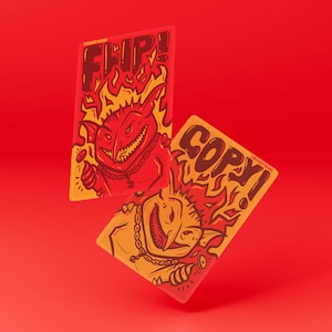 May include: Two rectangular stickers with cartoon devils on a red background. One sticker says "FLIP!" and the other says "COPY!". The devils are red and yellow with flames around their heads and are wearing chains.