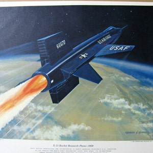 May include: A black and white illustration of the X-15 Rocket Research Plane, a rocket-powered aircraft, flying through the sky. The plane is labeled "US Air Force" and "USAF". The plane is flying over a blue and white planet with clouds. The text "66670" is visible on the plane. The text "X-15 Rocket Research Plane - 1959" is visible at the bottom of the image.