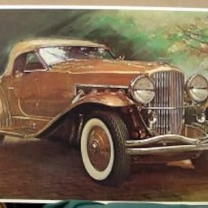 May include: A vintage brown convertible car with a white top and chrome accents. The car has a license plate that reads "165 THN".