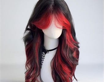 May include: A long, wavy wig with black and red highlights displayed on a mannequin head. The wig features a bold red fringe and streaks of red throughout the dark hair. A black choker necklace with a floral pendant is also visible.