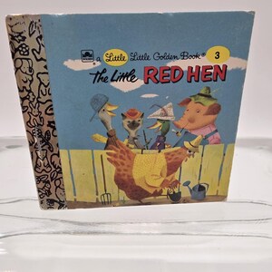 May include: A vintage Little Golden Book titled "The Little Red Hen." The cover features a blue background with illustrations of a red hen and other farm animals. The book's spine has a patterned design.