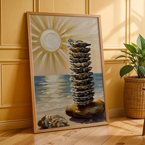 May include: A framed painting depicts a stack of oyster shells on a beach, with a setting sun and ocean in the background. The artwork is in a wooden frame and leans against a yellow wall. A potted plant in a woven basket sits nearby.