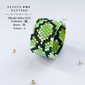 Wide peyote stitch beaded ring with a green and gold snake-skin inspired pattern. Made with shades of lime, dark green, white, and metallic gold beads. Displayed on a light background with scattered gold seed beads.