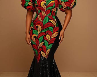 May include: A floor-length, off-the-shoulder gown with a fitted bodice and a flared skirt. The bodice features a vibrant pattern of red, green, and yellow leaves. The skirt is black and embellished with sequins. The dress has puffy sleeves.