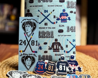 May include: A collection of hockey-themed items, including a light blue sleeve with hockey graphics and text, stickers, and jersey-shaped cutouts. The items feature the numbers 24 and 81, hockey sticks, and player illustrations.