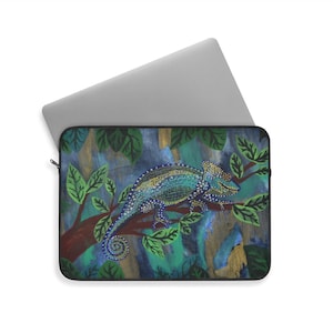 May include: A laptop sleeve featuring a colorful illustration of a chameleon perched on a tree branch. The chameleon is primarily blue and green, with a detailed pattern. The background has a painted look with shades of blue, green, and gold.