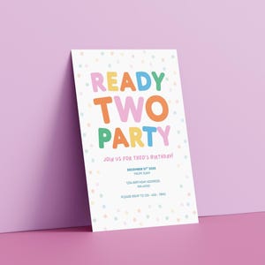May include: A white invitation card with the words "READY TWO PARTY" in colorful bubble letters. The card includes the text "JOIN US FOR THEO'S BIRTHDAY!" and event details. The background is a light purple.