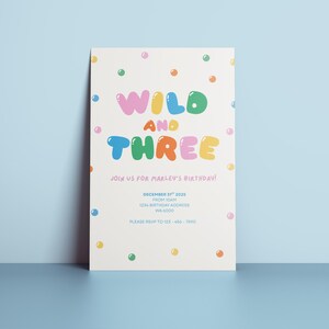 May include: A birthday invitation with the words "WILD AND THREE" in colourful bubble letters. The invitation includes the text "Join us for Marley's Birthday!" and event details. The invitation is decorated with colourful polka dots.