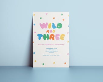 May include: A birthday invitation with the words "WILD AND THREE" in colourful bubble letters. The invitation includes the text "Join us for Marley's Birthday!" and event details. The invitation is decorated with colourful polka dots.