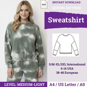 Może przedstawiać: Cyfrowy wykroj krawiecki na bluzę z nadrukiem tie-dye w kolorze szałwiowej zieleni i bieli. Dokument zawiera rysunek techniczny odzieży, rozmiary od S do 2XL, 6-16 USA, 38-48 europejskie oraz formaty A4, US Letter i A0.