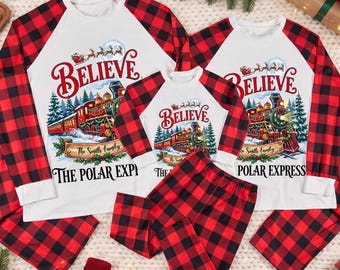 May include: Matching family pajama sets featuring white long-sleeve shirts with red and black buffalo plaid sleeves and pants. The shirts display a graphic of a steam train, the word BELIEVE, and the text THE POLAR EXPRESS with a family name.