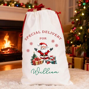 May include: A white Christmas sack with red trim and drawstring. The sack has a Santa Claus graphic and the words "Special Delivery For William" in red and green. Snowflakes are also printed on the sack.