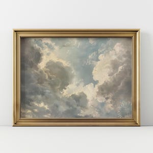 Könnte beinhalten: Ein gerahmtes Kunstwerk mit einer dramatischen Wolkenlandschaft in Grau-, Weiß- und Blautönen. Das Gemälde ist in einem goldfarbenen Rahmen eingefasst, der einen Hauch von Eleganz verleiht. Das Kunstwerk erzeugt ein Gefühl von Tiefe und Bewegung.