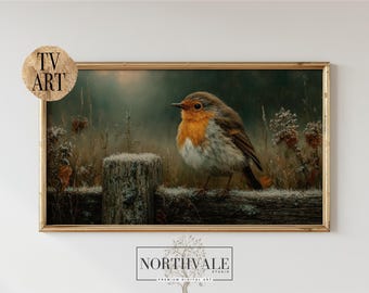May include: A framed print of a European robin, with a distinctive orange breast, perched on a wooden fence. The artwork is set in a naturalistic scene with muted colours. The print is labelled "TV ART" and "NORTHVALE STUDIO".
