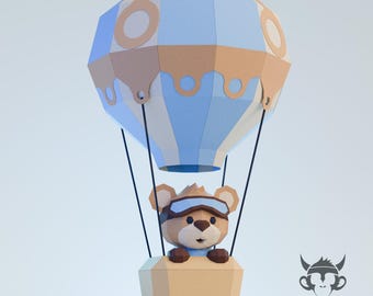 May include: A whimsical, low-poly style illustration of a teddy bear in a hot air balloon. The balloon features a blue and tan color scheme. The bear wears goggles and is in a tan basket. The image has a light blue background.