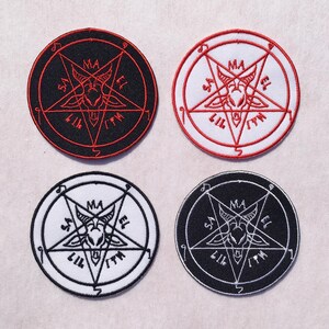 May include: Four circular embroidered patches featuring a central goat head inside a pentagram. Two patches have black backgrounds with red or white stitching, and two have white backgrounds with red or black stitching. Each includes the text MA, SA, EL, LIL, ITH.