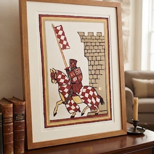 May include: A framed print featuring a medieval knight in red and white checkered armor riding a horse with matching red and white checkered barding. The knight holds a tall lance with a checkered flag, positioned beside a stone castle wall.