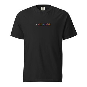 May include: Black t-shirt with the word "ultrathink" in rainbow colors. The word is preceded by a right-pointing arrow. The shirt is made of a soft material and has a classic crew neck.
