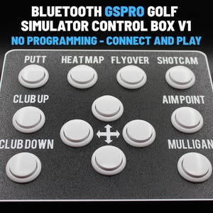 May include: A black control box with white buttons labeled for golf simulation functions. Text at the top reads "BLUETOOTH GSPRO GOLF SIMULATOR CONTROL BOX V1" and "NO PROGRAMMING - CONNECT AND PLAY". Buttons include "PUTT", "HEATMAP", "FLYOVER", and "SHOTCAM".