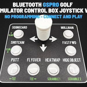 May include: A black Bluetooth GSPRO golf simulator control box joystick V2 with white buttons and white text. The device features labels including Scorecard, Mulligan, Shotcam, Fastfwd, Putt, Flyover, Heatmap, Hide Object, Club, Tee, and Scramble.