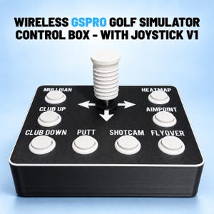 May include: A black wireless GSPRO golf simulator control box with a white joystick and eight white buttons labeled Mulligan, Club Up, Club Down, Putt, Heatmap, Aimpoint, Shotcam, and Flyover, featuring white directional arrows on the top surface.